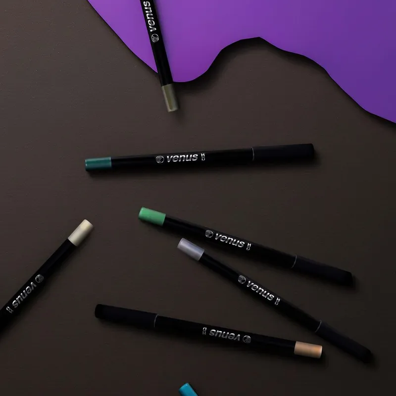 Branded eyeliner pencils styled on a colored background