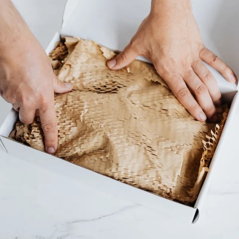 White mailer box packed with recyclable honeycomb kraft protective wrap