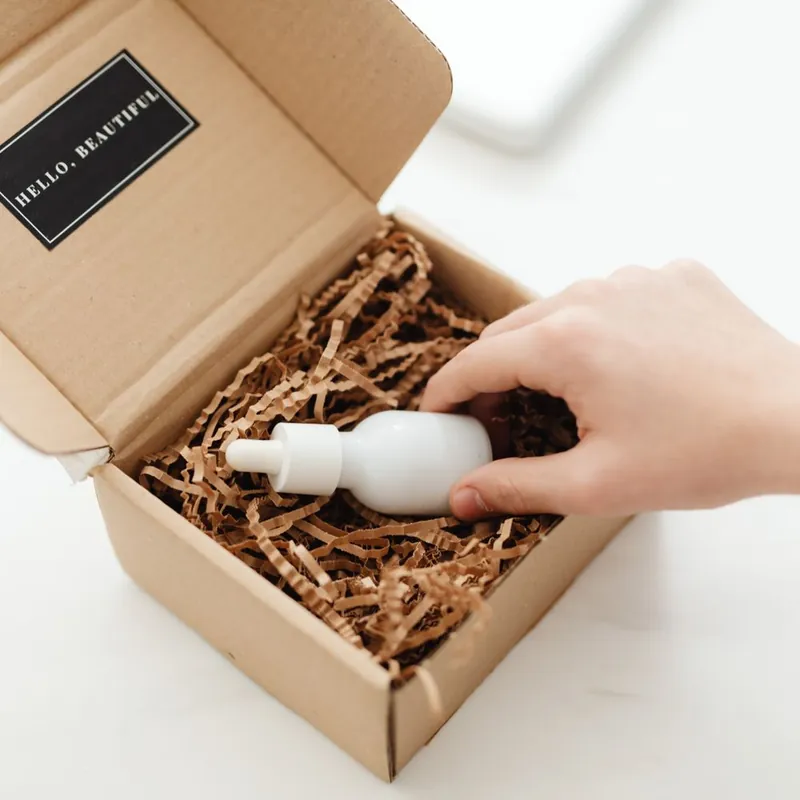 Eco-friendly kraft mailer box with recyclable fill for a California beauty unboxing