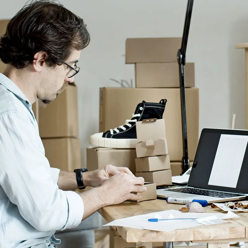 Florida e-commerce seller packing custom kraft product boxes at a desk