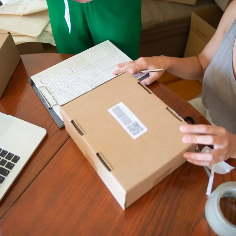 Florida small business owners packing and labeling a custom shipping box