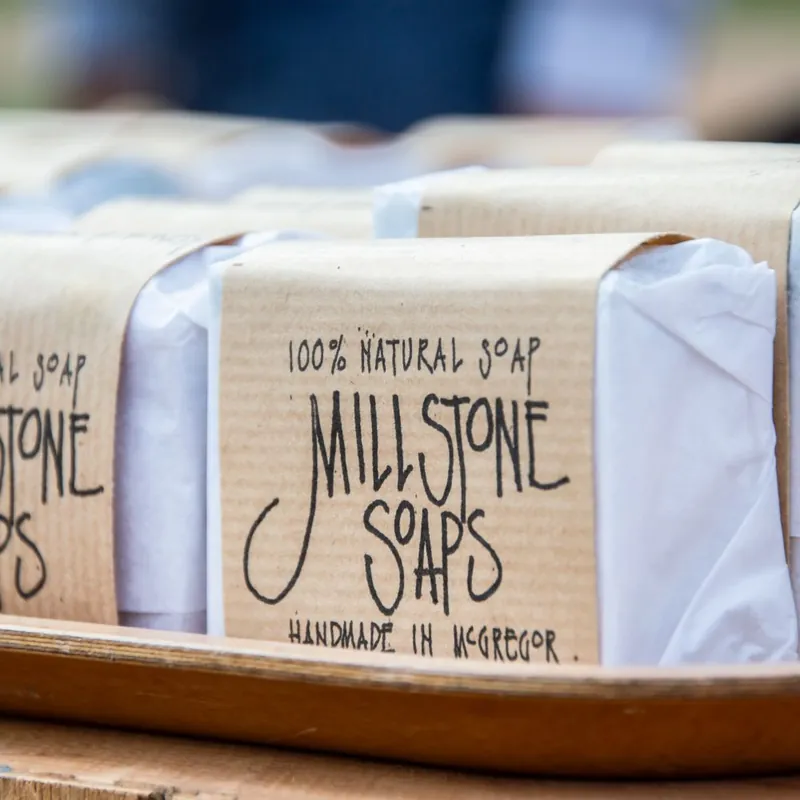 Handmade soap bars wrapped in printed kraft sleeves
