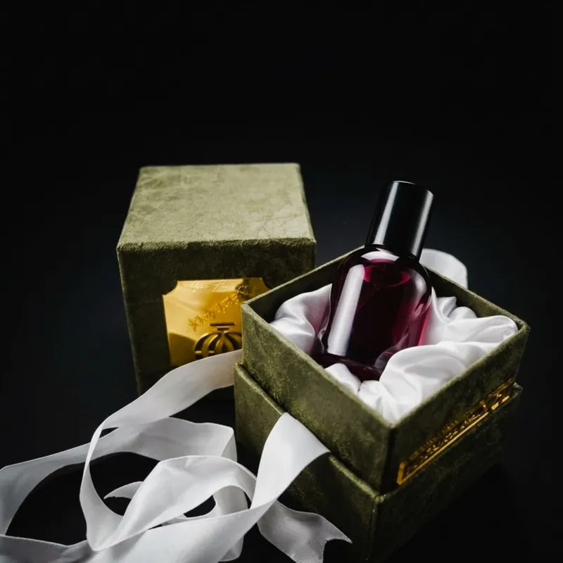 Luxury perfume bottle inside a velvet rigid box with satin lining