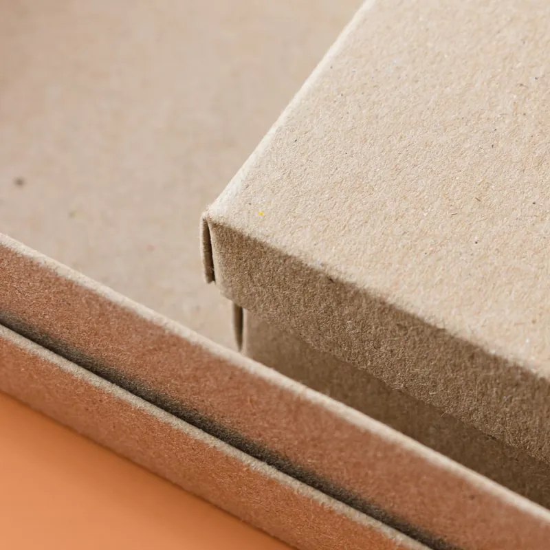 Close-up of recyclable kraft boxes showing natural recycled fiber texture