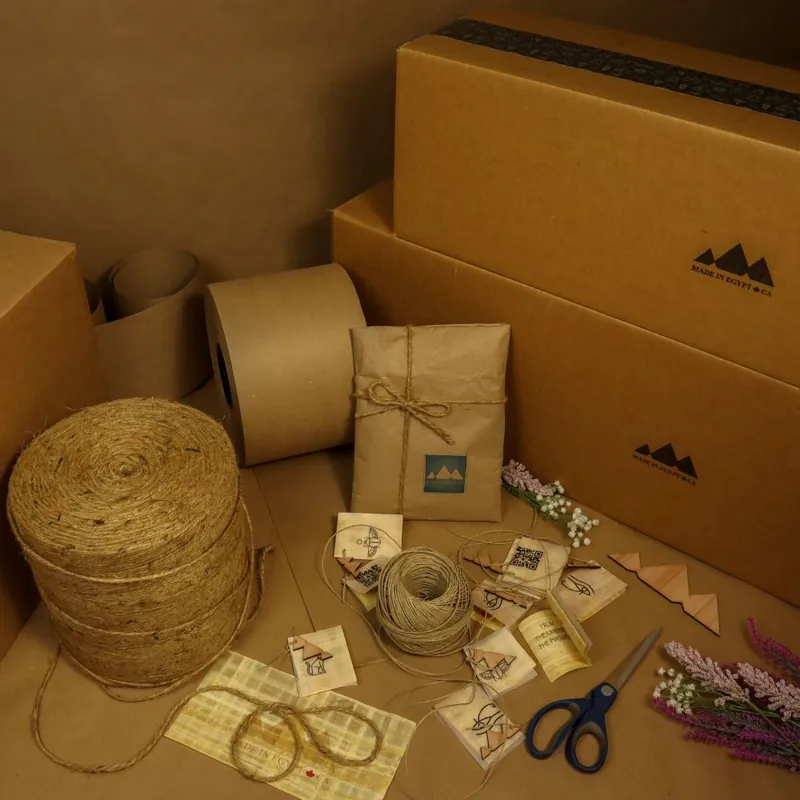 Sustainable packaging materials including kraft boxes, paper roll, and natural twine